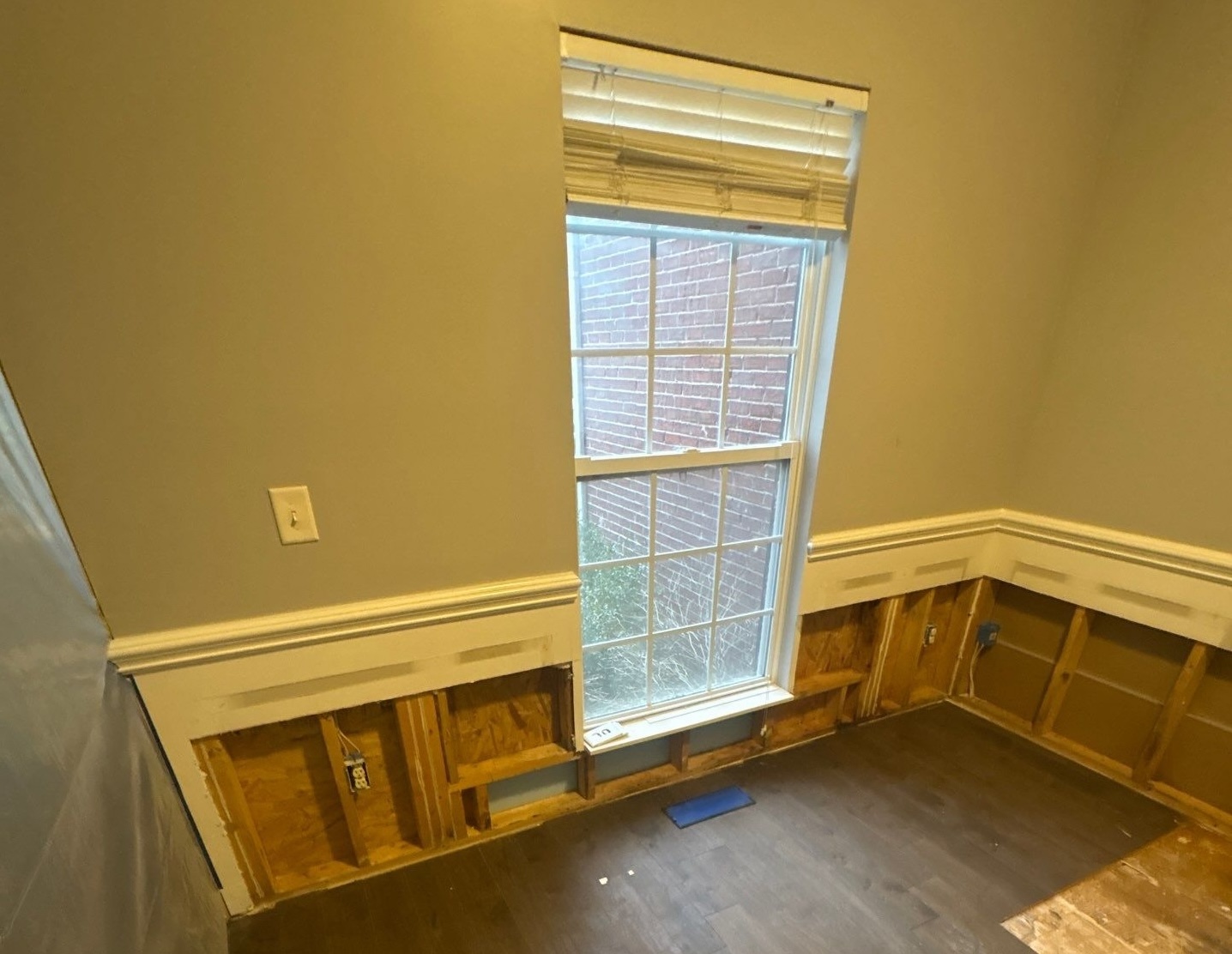 Wall framing exposed during demolition phase of a residential water damage rebuild